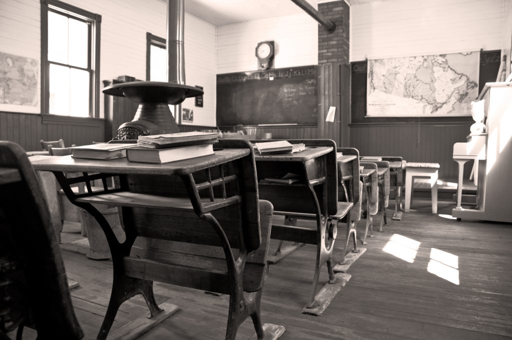 In sepia, a student's view towards the front of a 110 year old one room rural school. Restored
